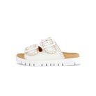 White sandal with brown sole on a white background