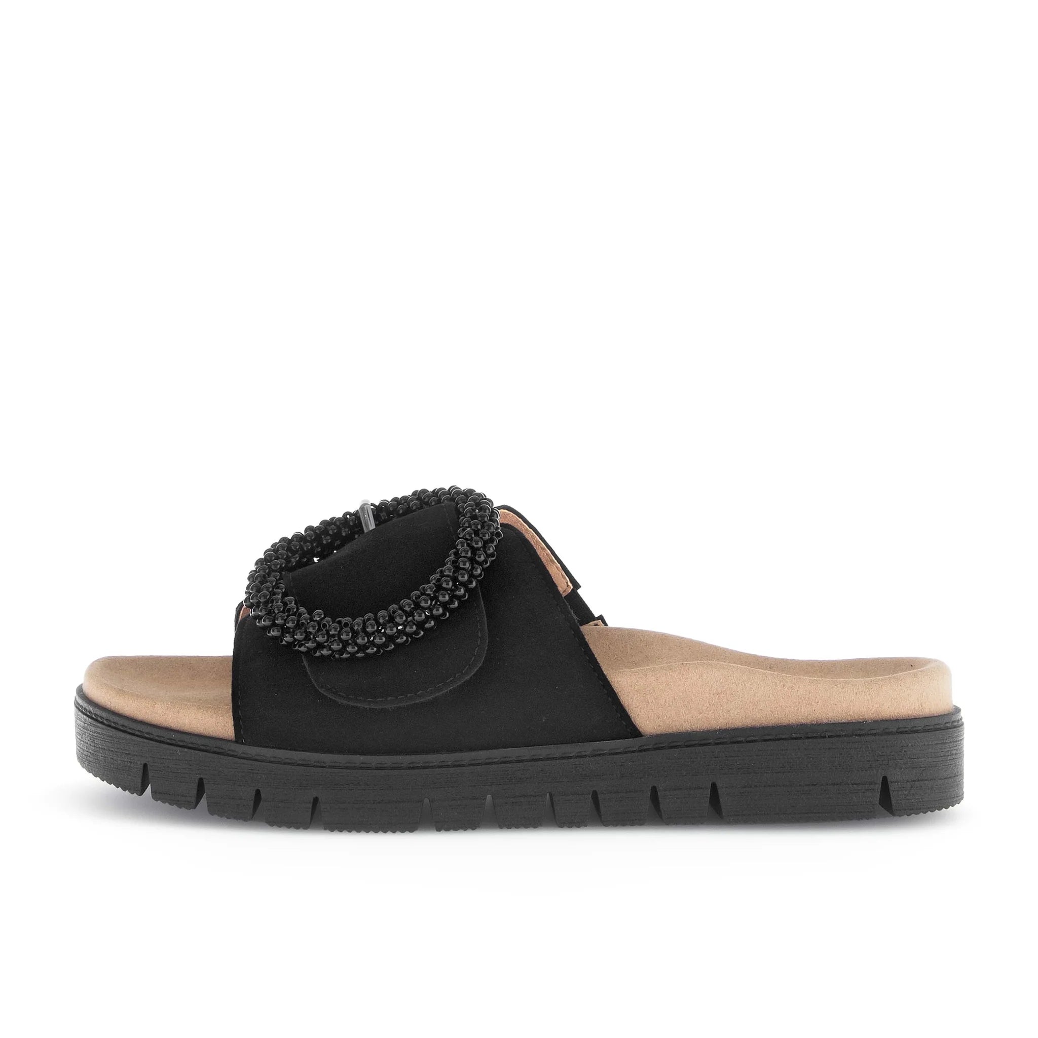 Black sandal with beaded strap on a white background
