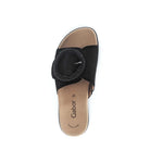 Black sandal with a circular design on a white background