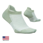 A pair of low-cut athletic socks in a pale sage green and white colorway, shown on a light cream background with a 'Made in the USA' flag graphic in the bottom-left corner.