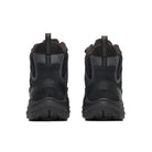 A pair of black and dark gray rugged outdoor boots shown from the back, featuring thick lugged soles and textured synthetic and suede-like uppers, set against a plain white background.