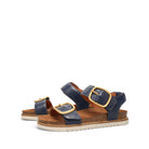 Pair of blue sandals with gold buckles on a white background