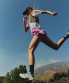 Person running outdoors with mountains in the background