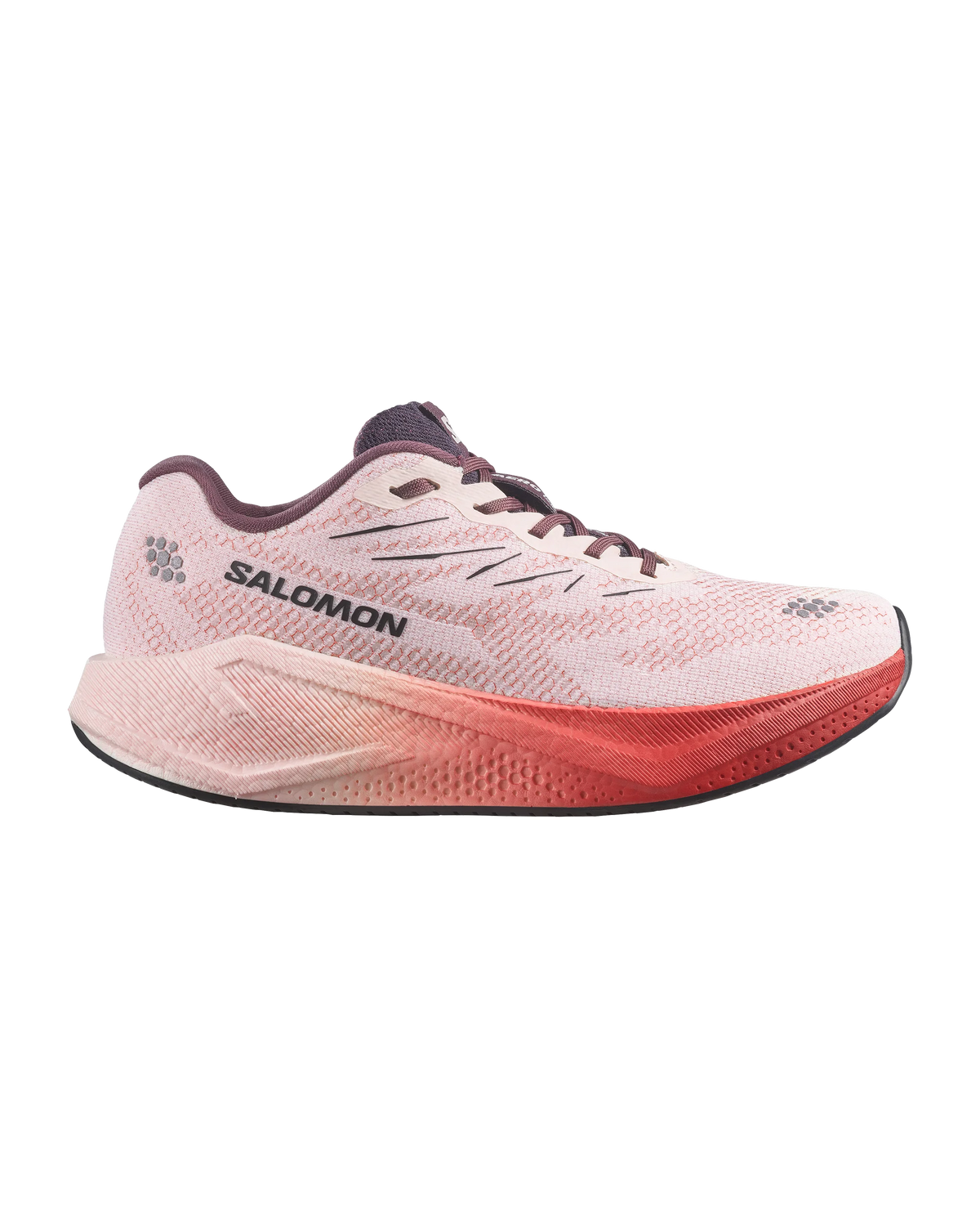 A Salomon running shoe in light pink and coral red, shown from a side profile on a plain white background.