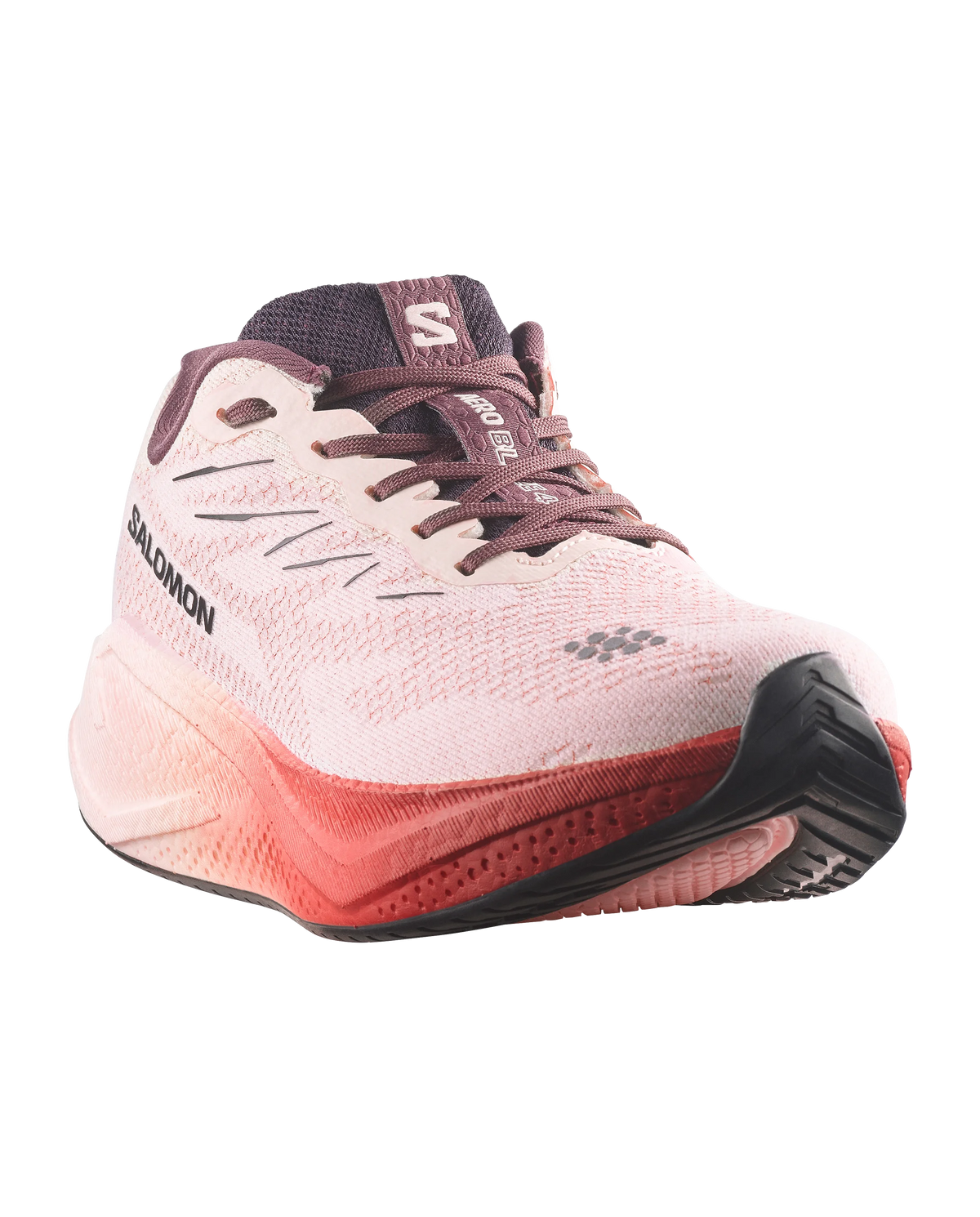Salomon running shoe in light pink and coral red with dark purple accents, shown from a three-quarters angle on a white background.