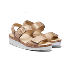 Pair of gold sandals with cork sole on a white background
