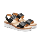 Black sandals with cork platform and white sole on a white background