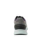 Gray athletic shoe with purple accents on a white background