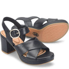 Black block-heel sandals with a gold buckle on a white background