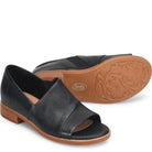 Black sandal with brown sole on a white background