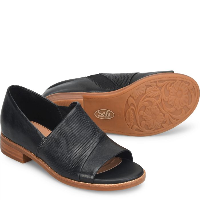 Black sandal with brown sole on a white background