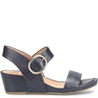 Navy blue sandal with a round buckle on a white background