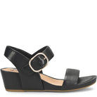 Black sandal with a gold buckle on a white background