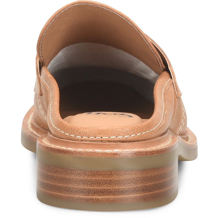 A close-up rear view of a tan leather slip-on shoe with a chunky, layered platform sole, shown on a white background.