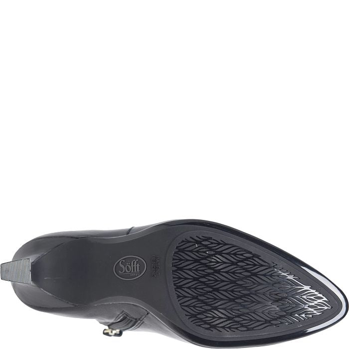 A close-up, top-down view of a black pointed-toe shoe sole, showing the tread pattern and a circular 'Soft' logo on the heel area, set against a plain white background.