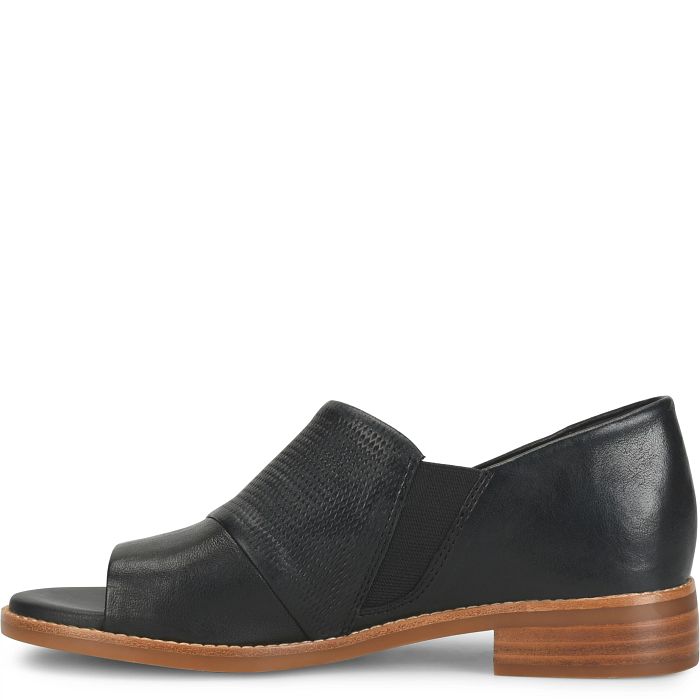 Black leather shoe with a brown sole on a white background