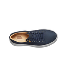 Navy blue sneaker with a visible brand label on a white background