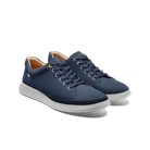Pair of navy blue sneakers with white soles on a white background