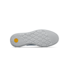 Close-up of a shoe sole with a textured pattern and a yellow circular logo on a white background
