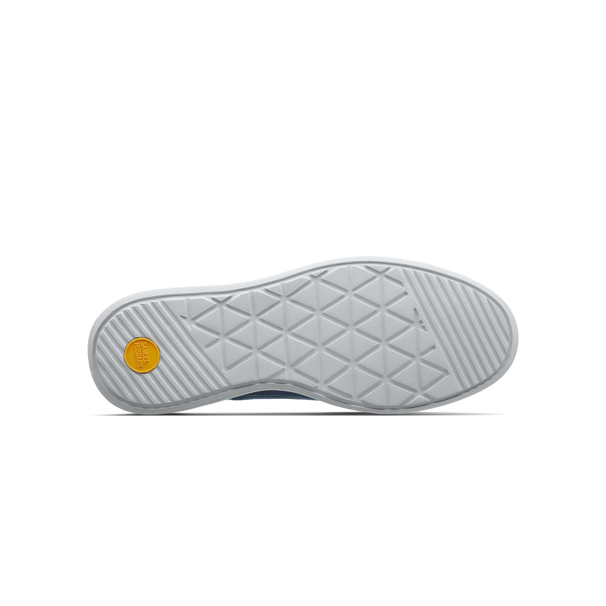 Close-up of a shoe sole with a textured pattern and a yellow circular logo on a white background