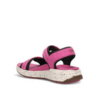Pink sandal with a speckled sole on a white background