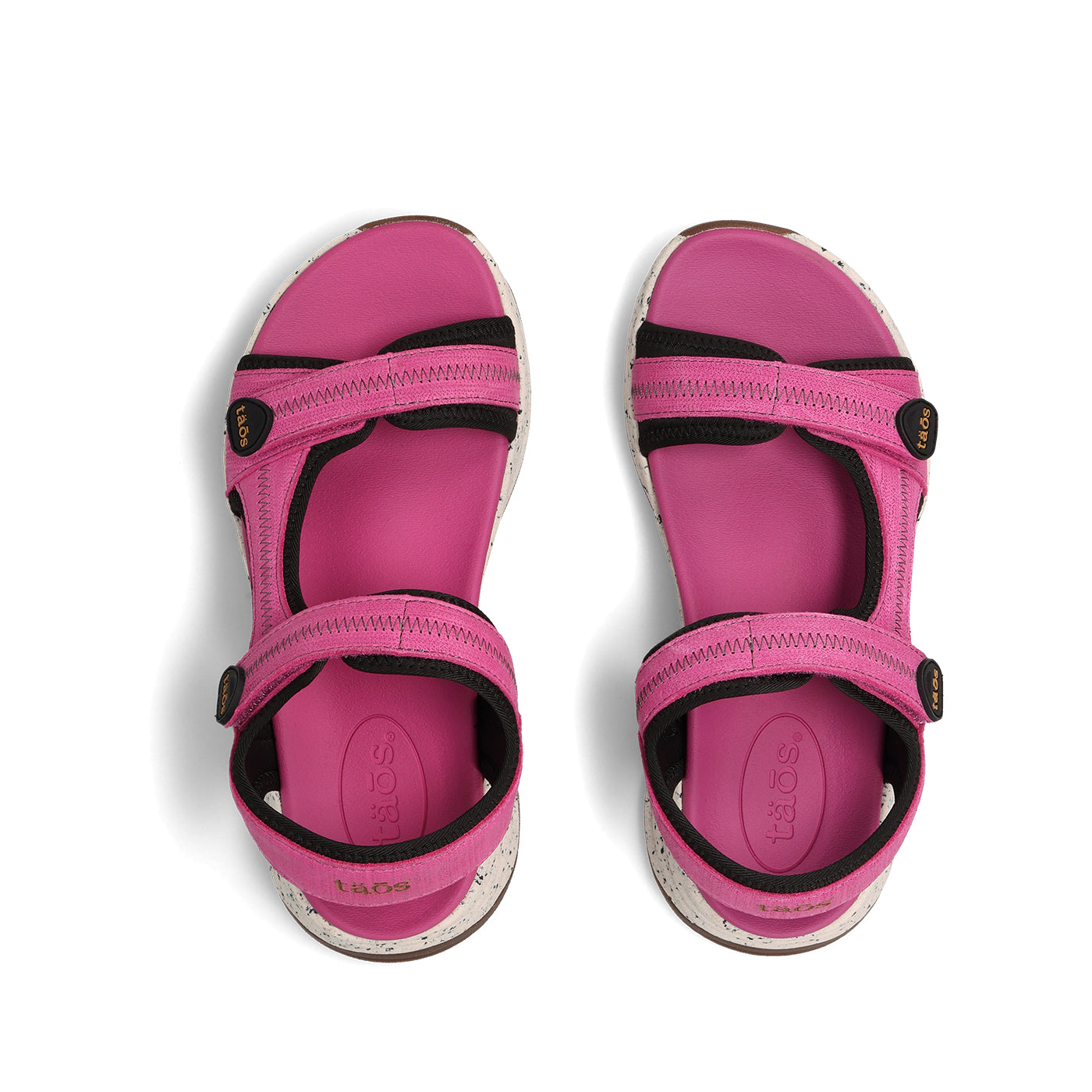 Pink sandals with black straps on a white background