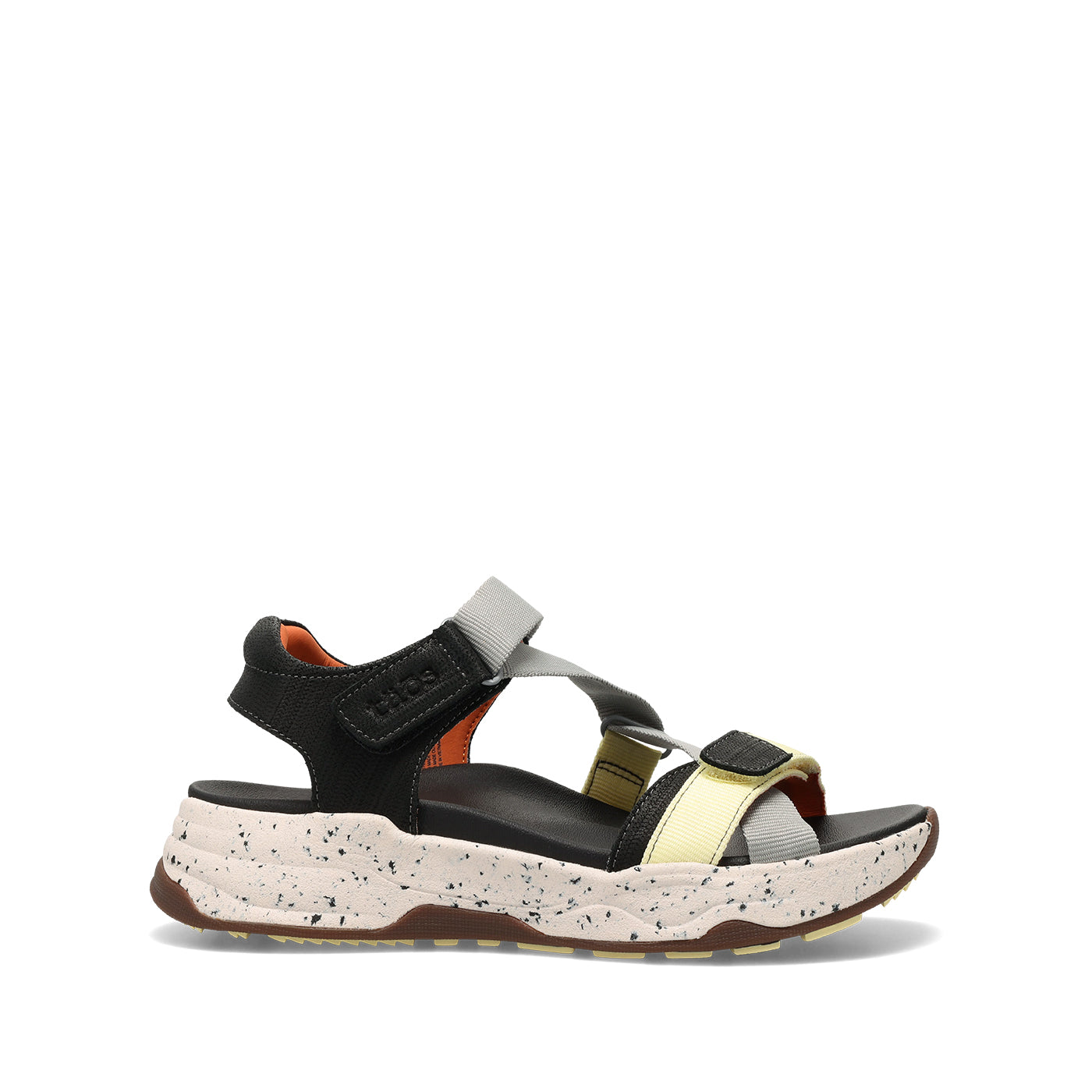Black and gold sandal with a speckled sole on a white background