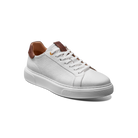 White sneaker with brown accents on a white background