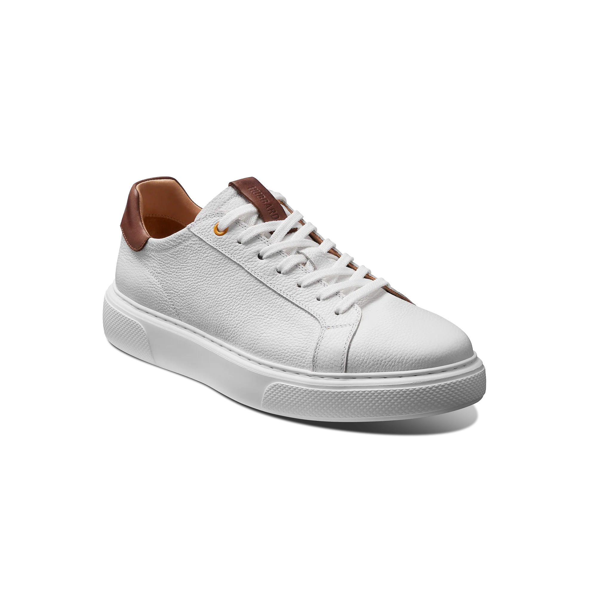 White sneaker with brown accents on a white background