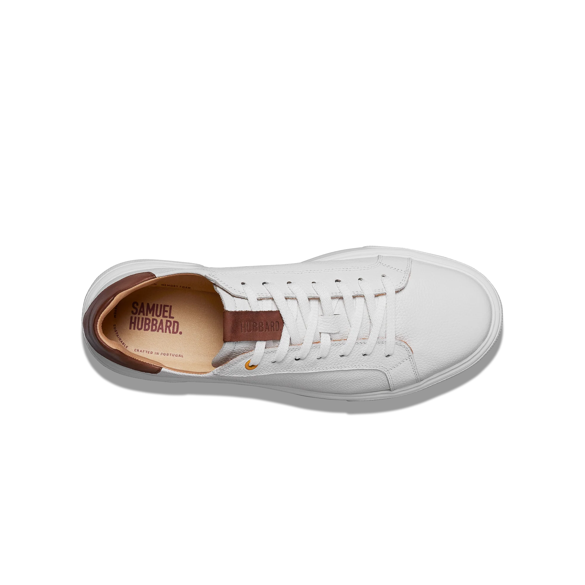 White sneaker with brown insole on a white background