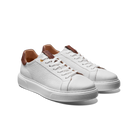 White sneakers with brown accents on a white background