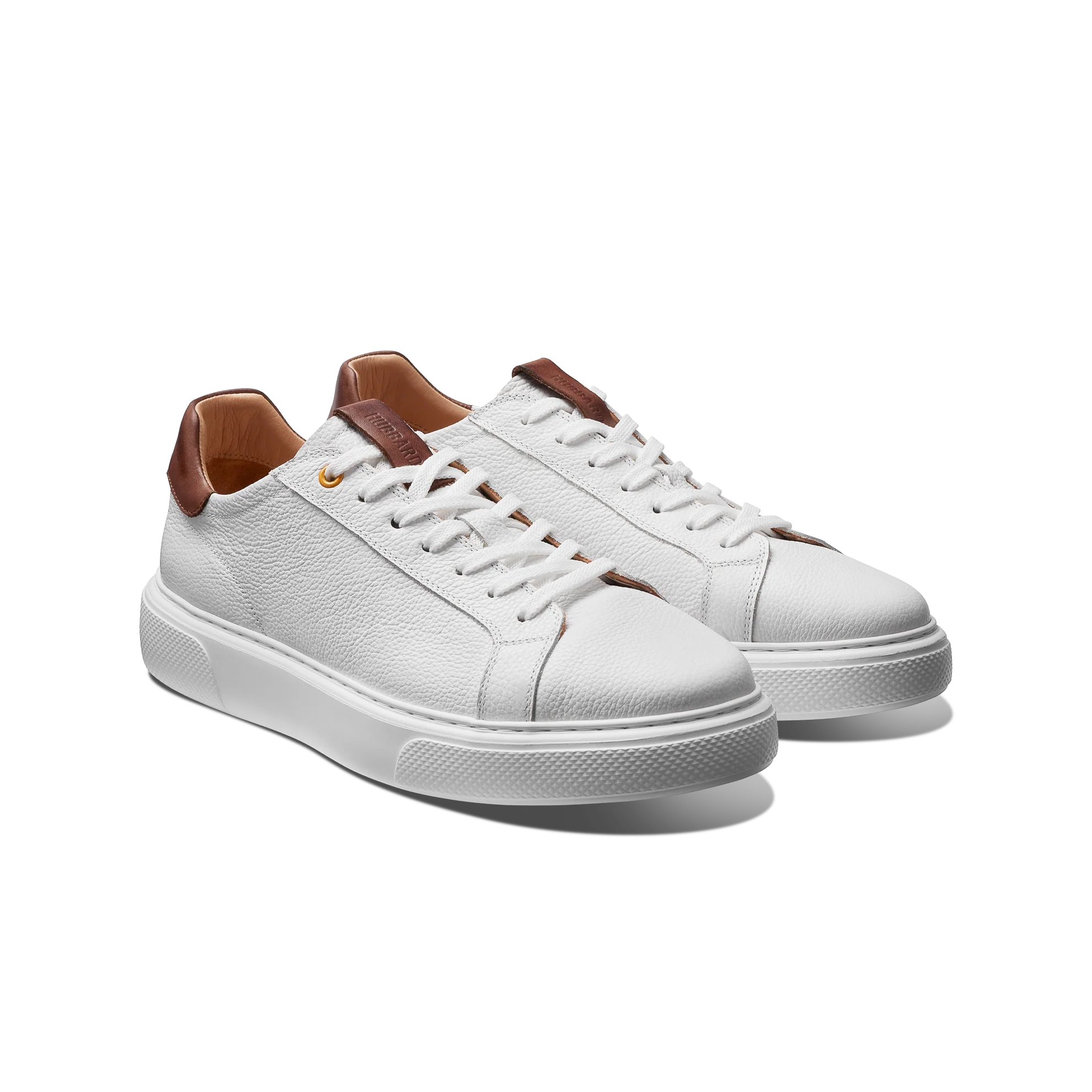 White sneakers with brown accents on a white background