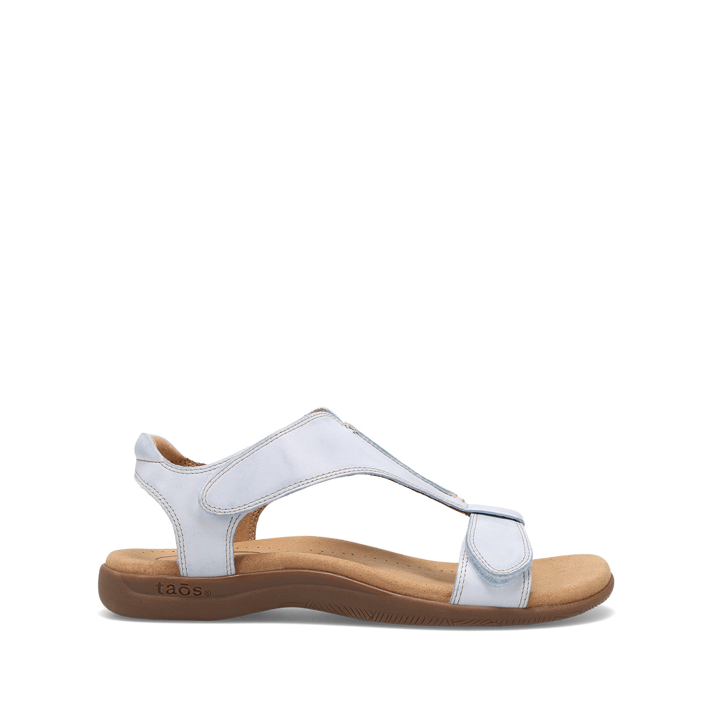 White sandal with brown sole on a white background