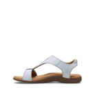 White sandal with a brown sole on a white background