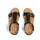 Tan sandals with black straps and 'taos' branding on a white background