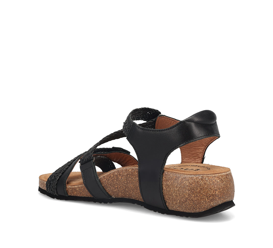 Black sandal with braided straps on a white background