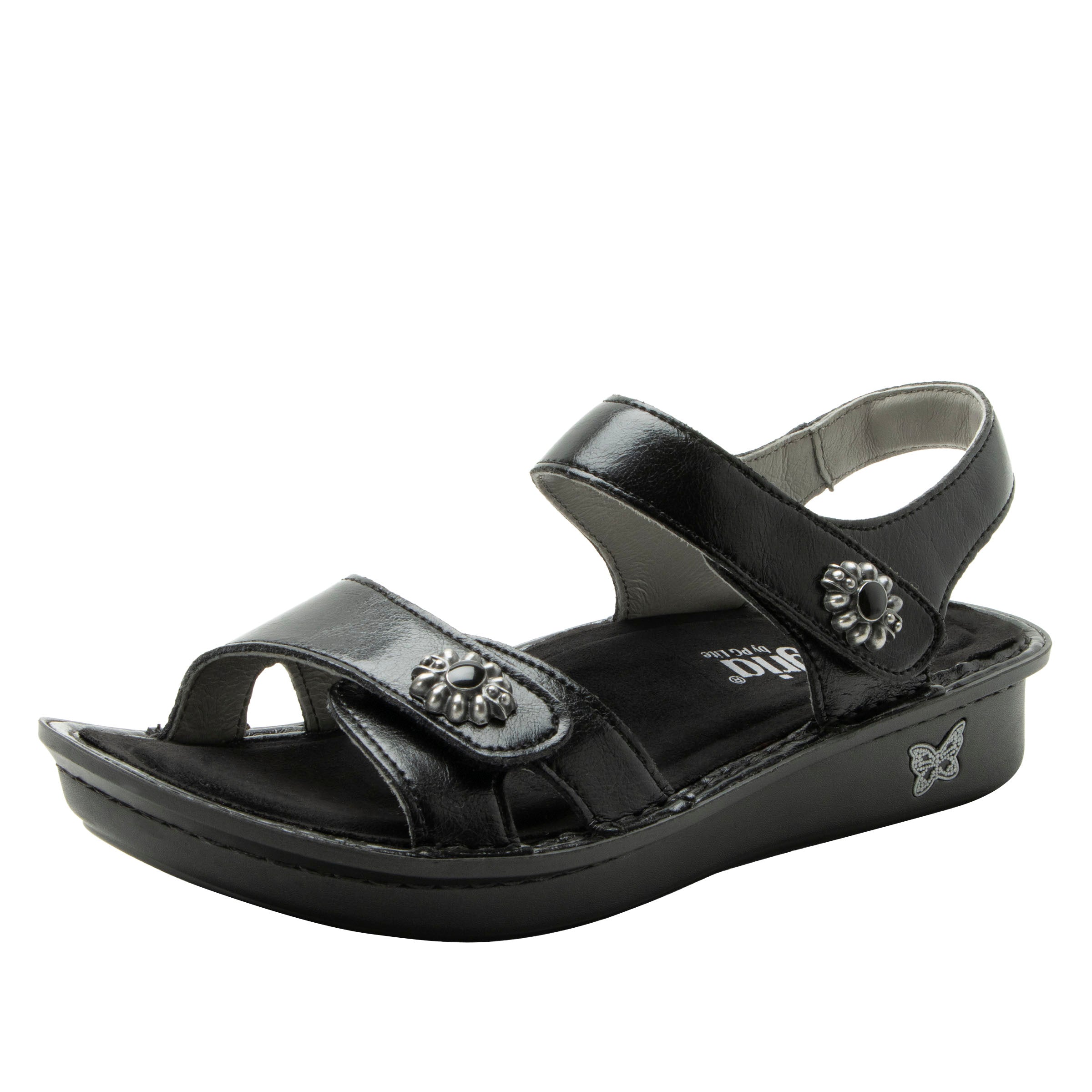 Black sandal with decorative straps on a white background