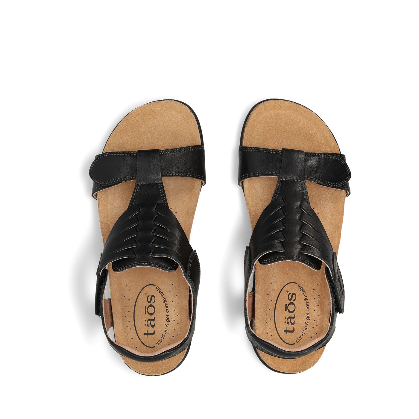 Black sandals with tan soles on a white background