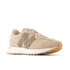 Beige sneaker with leopard print accents on a white background