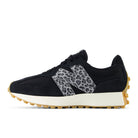Black sneaker with leopard print accents on a white background