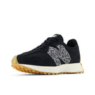 Black sneaker with a leopard print pattern on a white background