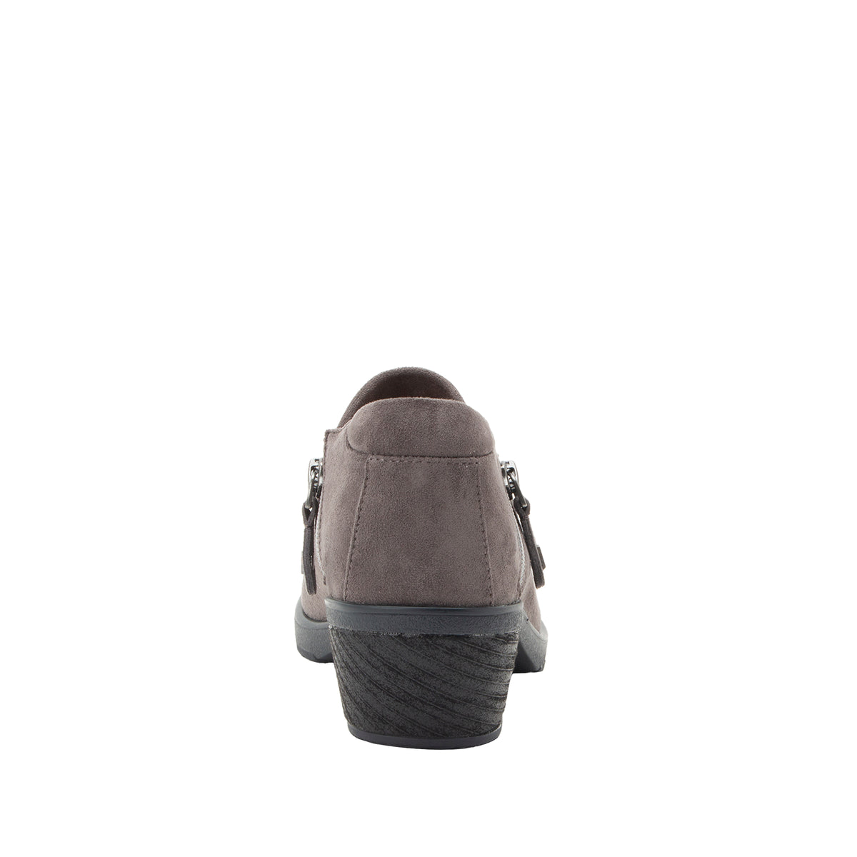 A single women's slip-on shoe shown from the back, featuring a taupe-brown suede upper, a dark gray textured wedge heel, and silver-tone metal side hardware, set against a plain white background.