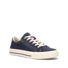 A navy blue low-top sneaker with a side zipper, cream-colored laces, and a thick cream-colored rubber sole, shown from a three-quarters angle on a white background.