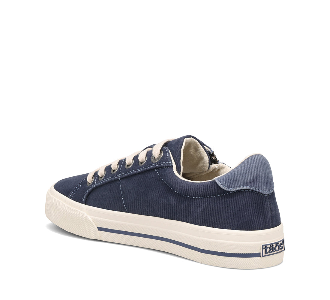 Navy blue sneaker with white laces on a white background