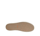 Close-up of a shoe sole with a brand logo on a white background