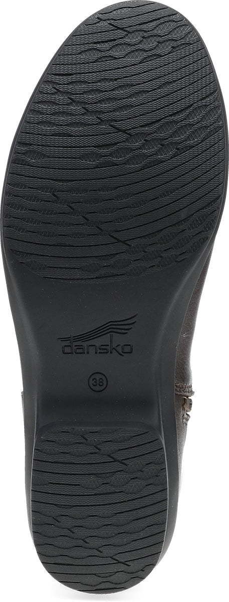 A close-up view of the black rubber outsole of a boot, showing the tread pattern and the 'dansk' brand logo printed in the center.