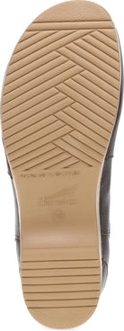 Close-up of the tan rubber outsole of a shoe, showing tread pattern and embossed branding, with a dark gray side panel visible at the edges.