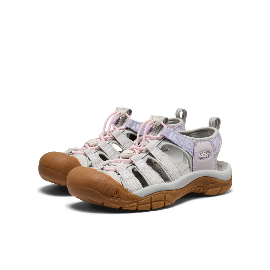 Pair of sandals with brown soles and pink laces on a white background