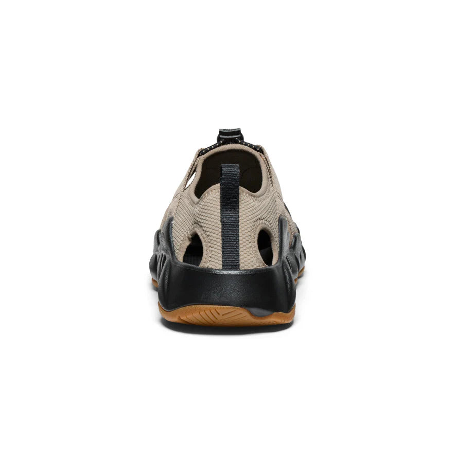 Sandal with beige and black design on a white background