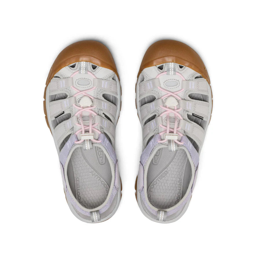 Pair of gray sandals with brown soles on a white background